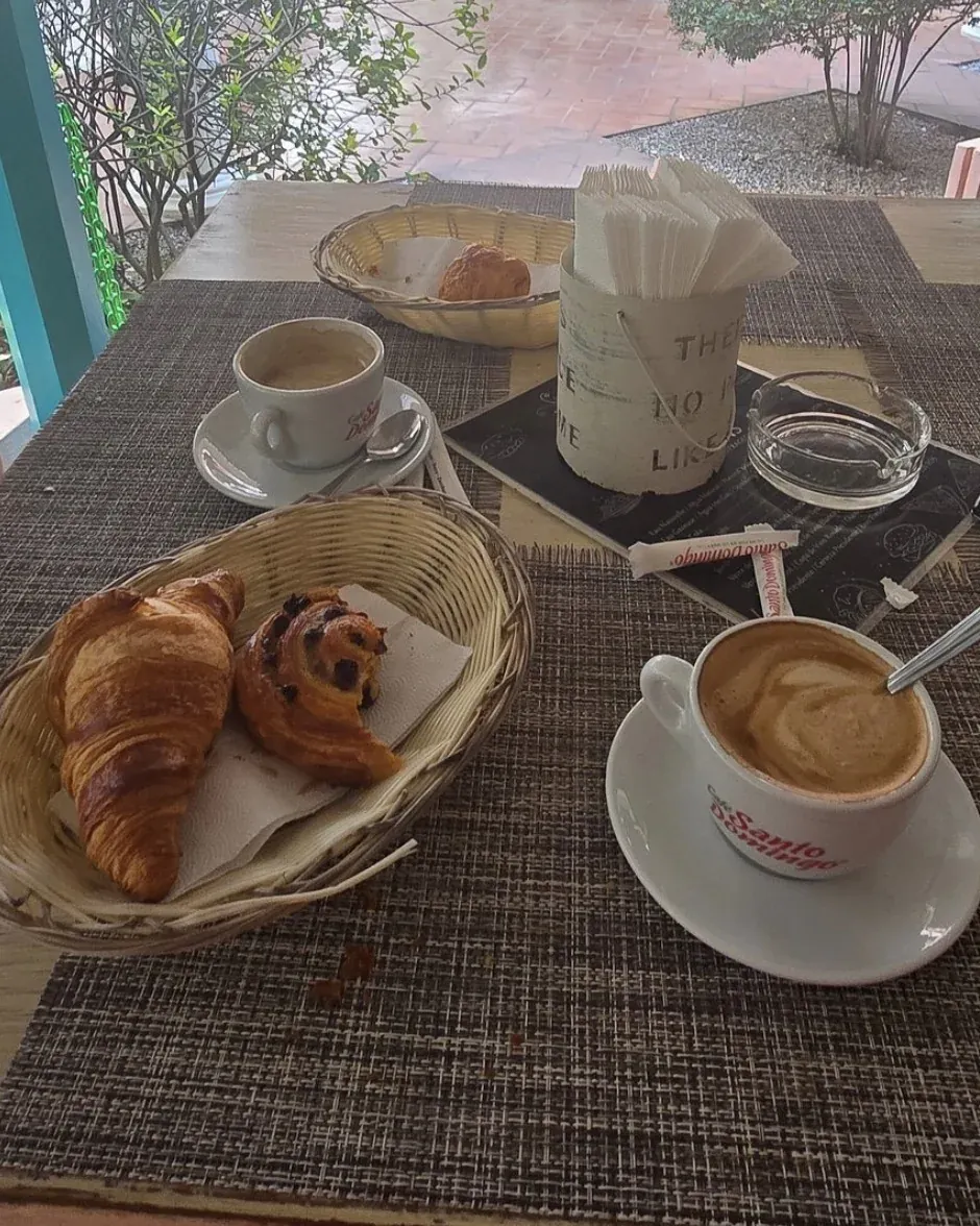 Breakfast at Boulangerie Jean: croissant, pain au chocolat and coffees in the gallery